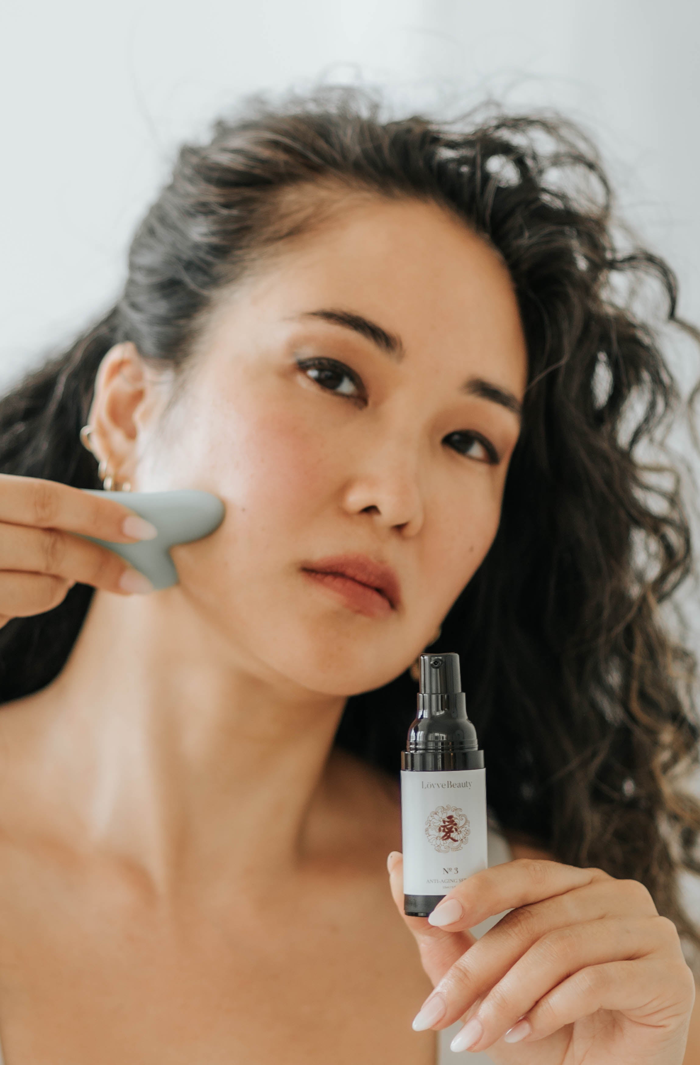 Lovve Beauty Anti-Aging Serum with Model and Gua Sha